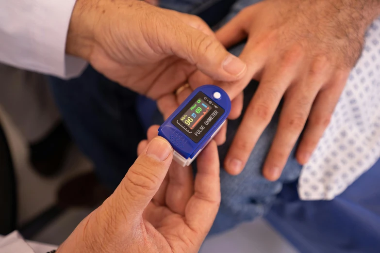 a close up of a person holding a cell phone, vitals visualiser!!, small in size, thumbnail, blue