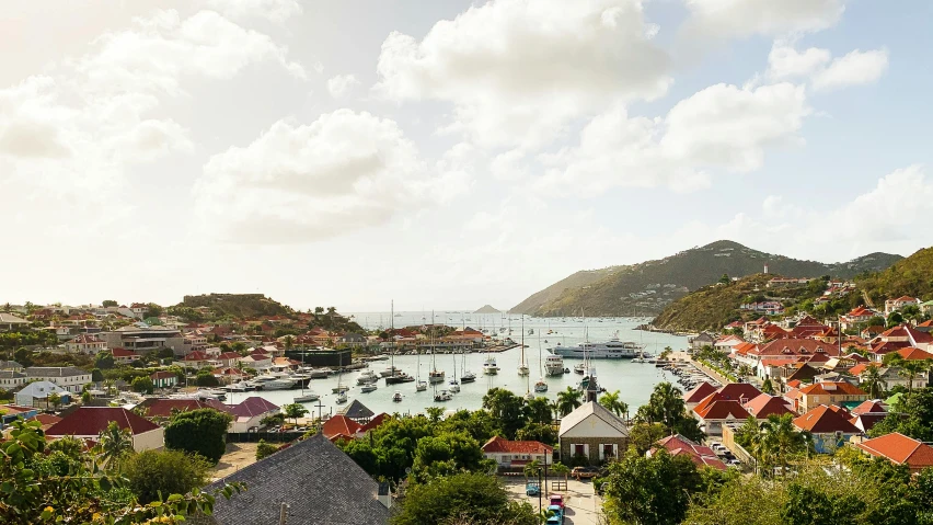 a large body of water filled with lots of boats, a photo, by David Brewster, pexels contest winner, caribbean, tiled roofs, peter hurley, slightly sunny