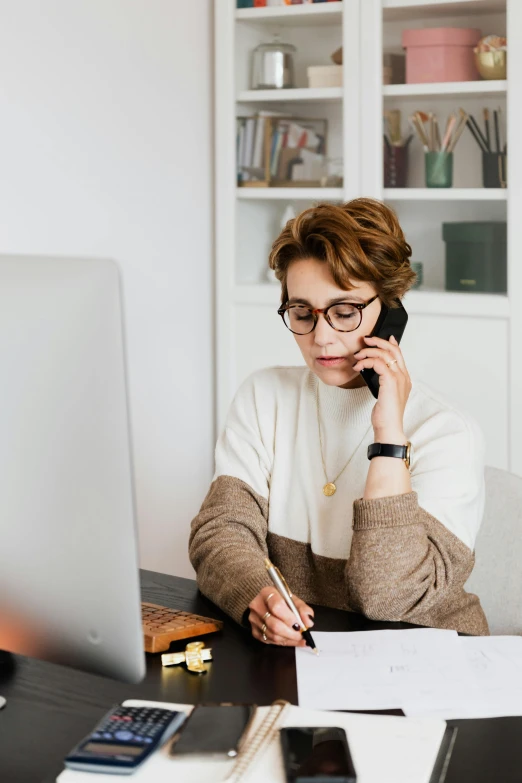 a woman sitting at a desk talking on a cell phone, trending on pexels, brown and white color scheme, looking serious, selling insurance, studious