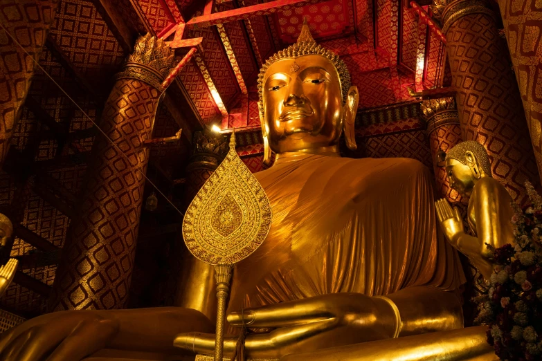 a large golden buddha statue inside of a building, long trunk holding a wand, thumbnail, mesmerising, underground temple