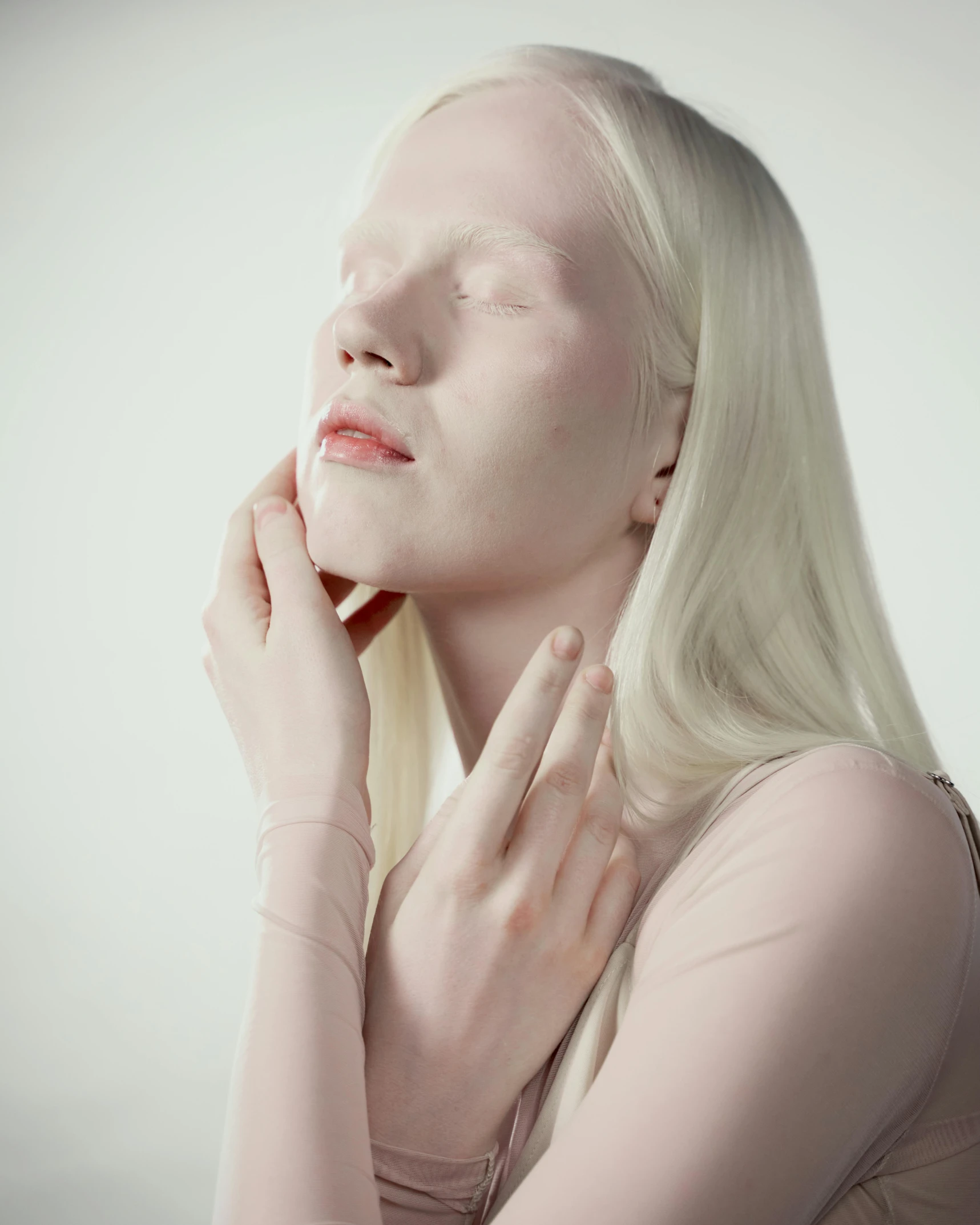 a woman with white skin holding her hand to her face, inspired by Vanessa Beecroft, aestheticism, intense albino, skincare, pastel', silicone skin