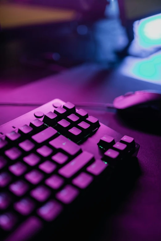 a computer keyboard sitting on top of a desk, purple - tinted, playing games, mouse, magenta