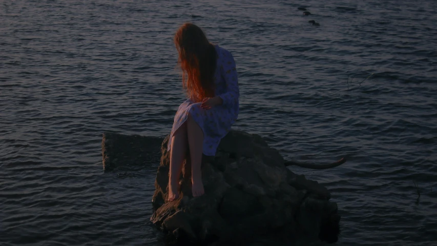 a woman sitting on a rock in the water, an album cover, by Attila Meszlenyi, pexels contest winner, romanticism, lorde, late evening, heartbroken, lo-fi