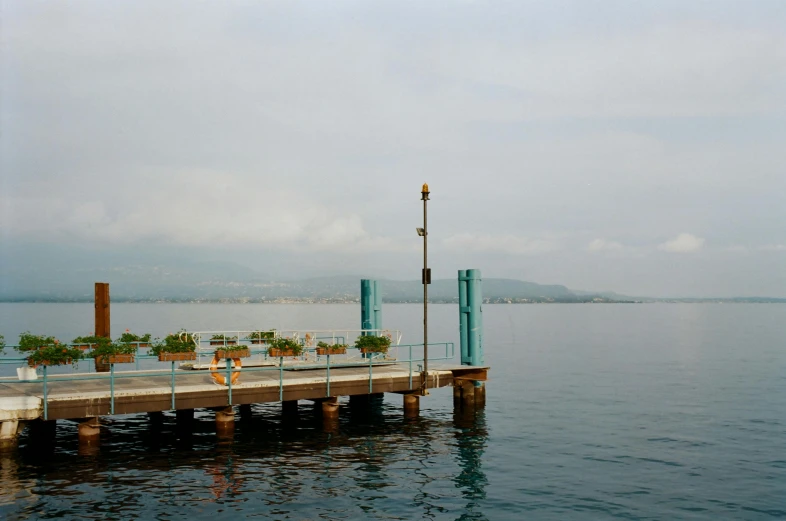 a pier in the middle of a body of water, by Yasushi Sugiyama, photo of zurich, jamaica, slight haze, 2022 photograph