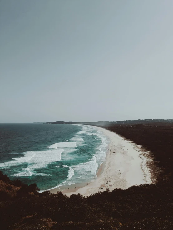 a view of a beach from the top of a hill, pexels contest winner, trending on vsco, australian beach, slight overcast, bird\'s eye view