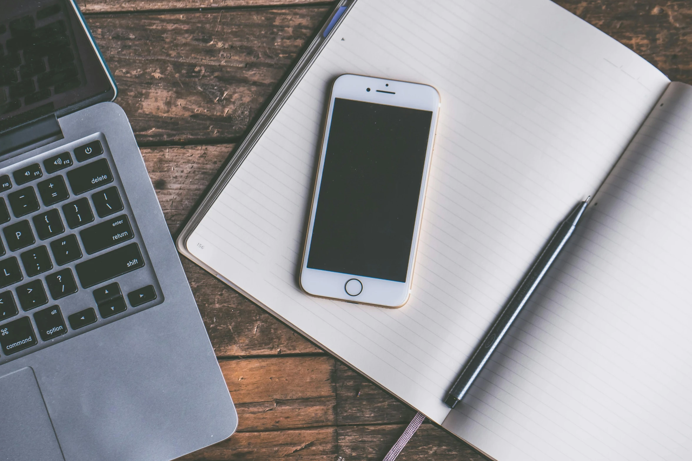 a cell phone sitting on top of a notebook next to a laptop, a picture, trending on pexels, professional iphone photo, 9 9 designs, brown, various posed