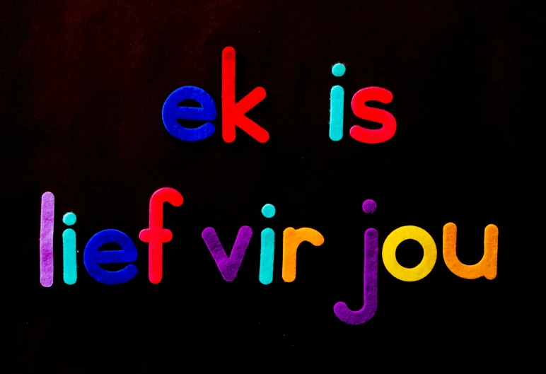 the words eek is life vir jou are spelled in multicolored letters on a black background, flickr, de stijl, elvish, morning time, for junior, color ( sony a 7 r iv