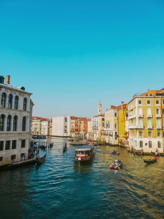 a canal filled with lots of boats next to tall buildings, inspired by Quirizio di Giovanni da Murano, pexels contest winner, renaissance, bright sunny day, venice biennale's golden lion, today\'s featured photograph 4k, wide high angle view