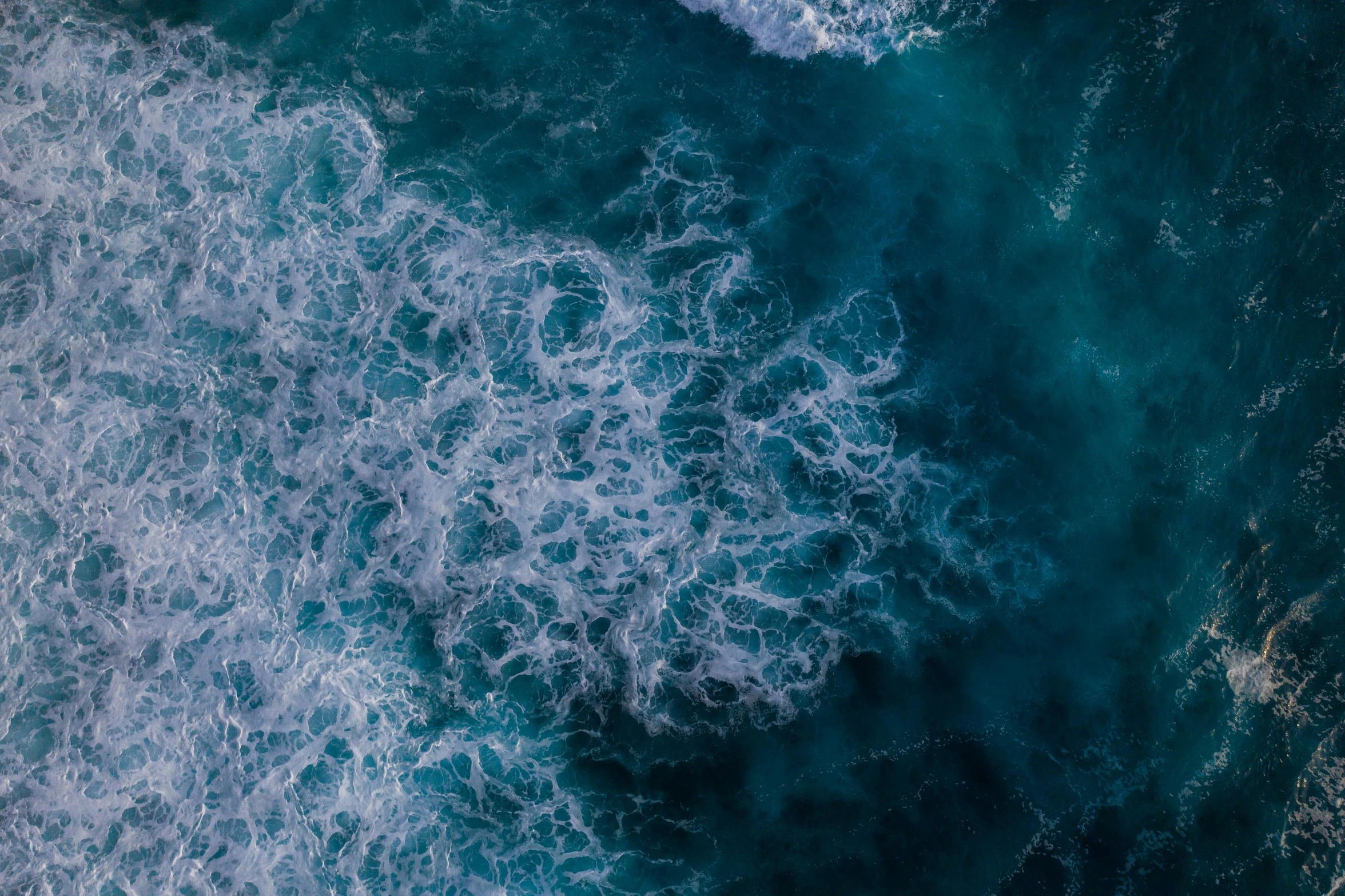 an aerial view of a body of water, pexels contest winner, generative art, ocean spray, manly, turbulence, feature