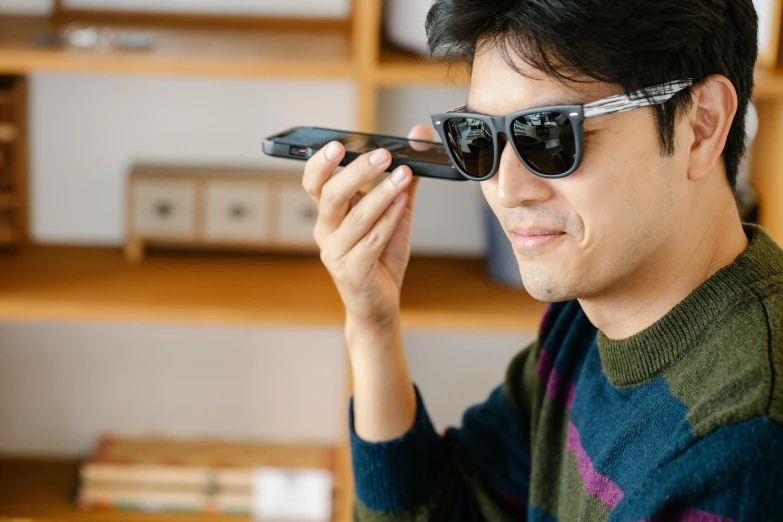 a close up of a person holding a cell phone, shin hanga, sunglasses, japanese collection product, looking to the side off camera, kano)