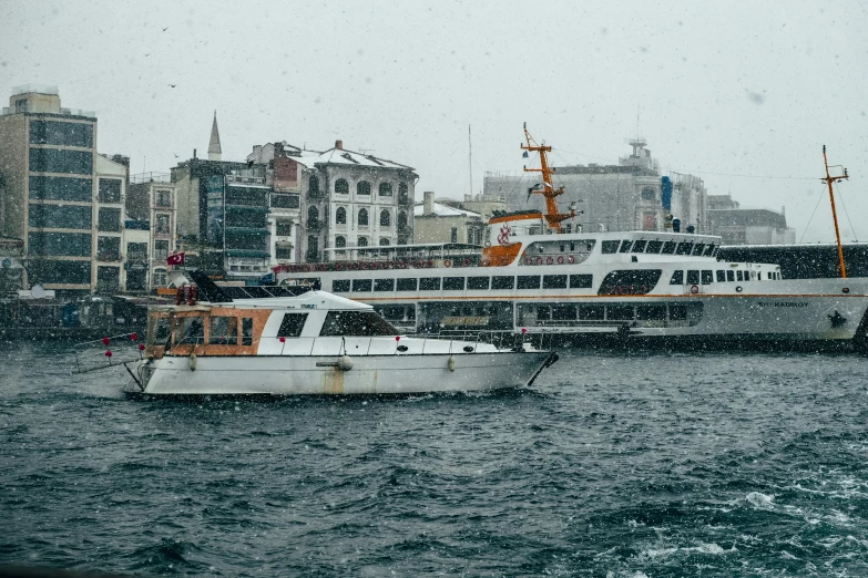 a couple of boats that are in the water, a photo, pexels contest winner, hurufiyya, snow flurries, fallout style istanbul, thumbnail, 🚿🗝📝