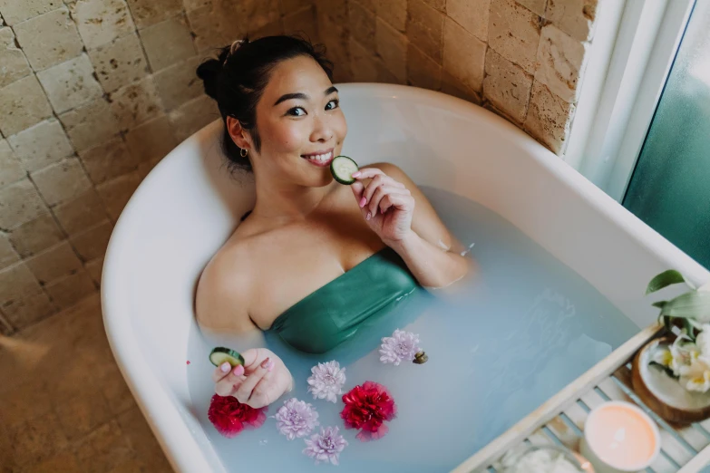 a woman in a bathtub holding a slice of cucumber, pexels contest winner, jamie chung, with lotus flowers, playful vibe, bao pham