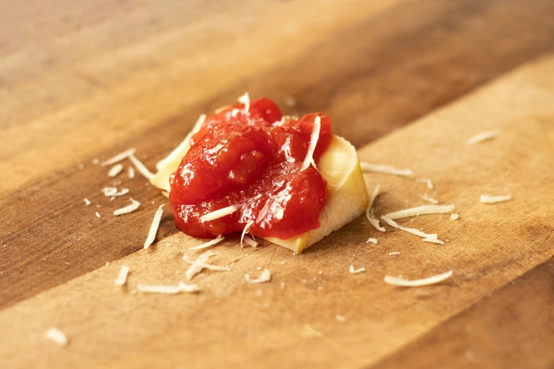 a piece of pizza sitting on top of a wooden cutting board, inspired by Tommaso Masaccio, private press, red, cheesy, relish, handcrafted