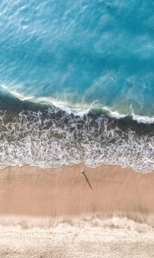 an aerial view of a beach and the ocean, by Robbie Trevino, pexels contest winner, minimalism, tall backlit waves, manly, ultrawide image, bird view