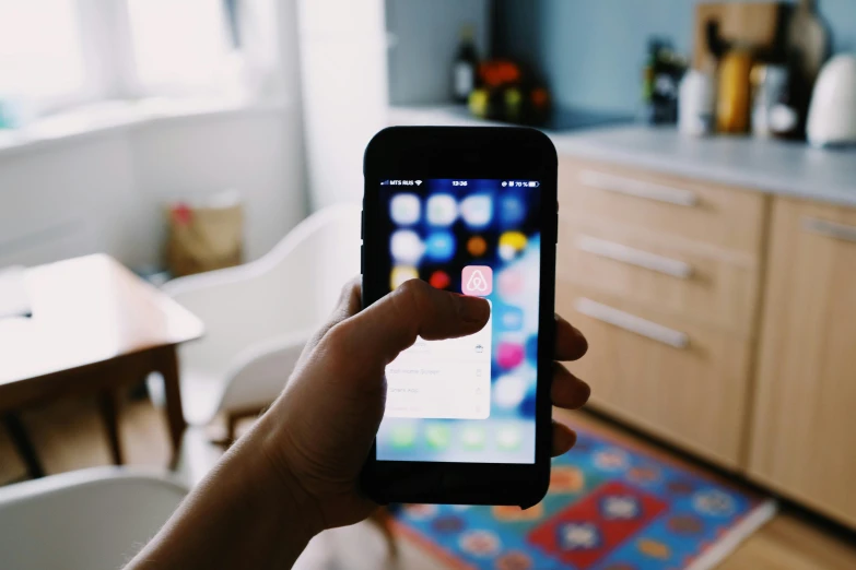 a person holding a smart phone in their hand, by Carey Morris, pexels, square, at home, reddit post, ios app icon