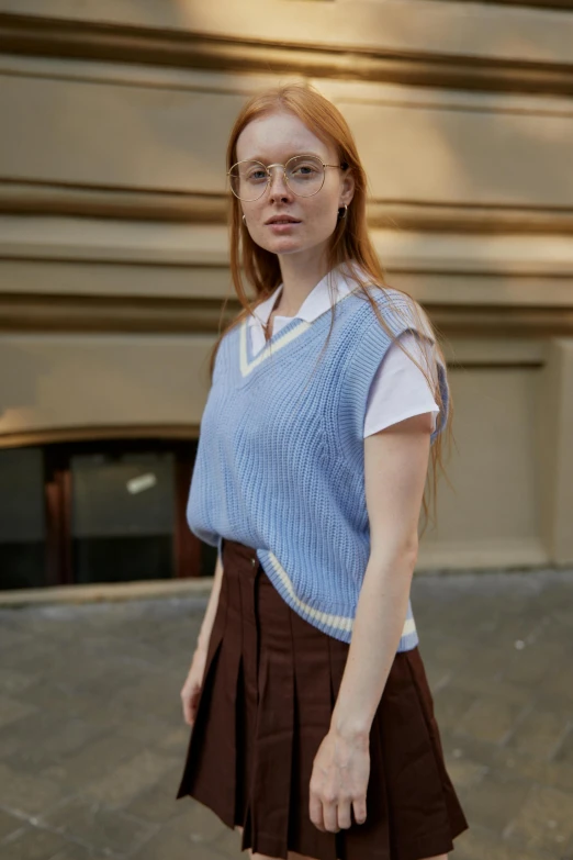 a woman in a blue sweater and brown skirt, wearing a vest top, federation clothing, wearing a light blue shirt, lily frank