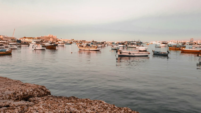 a large body of water filled with lots of boats, by Julia Pishtar, pexels contest winner, dau-al-set, lebanon kirsten dunst, late summer evening, faded glow, sea ground