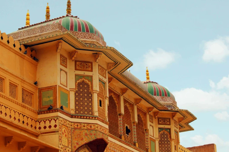 a horse is standing in front of a building, inspired by Frederick Goodall, pexels contest winner, renaissance, indian patterns, colorful architecture, palace on top of the hill, inlaid with gold