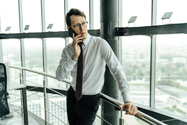 a man in a white shirt and tie talking on a cell phone, by Andries Stock, pexels contest winner, happening, top floor boss shit, elegant cinematic pose, man with glasses, thoughtful )