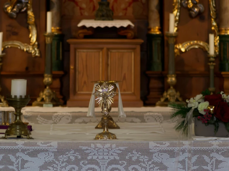 a couple of candles sitting on top of a table, standing in front of the altar, religious robes, profile image, decorations
