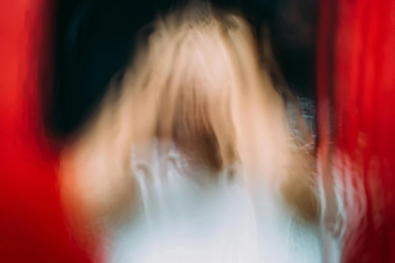 a blurry photo of a woman with blonde hair, pexels contest winner, lyrical abstraction, red aura, trapped egos in physical reality, small hairs, unsettling image