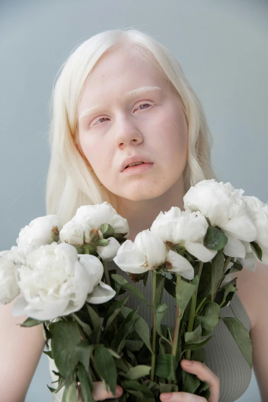 a woman holding a bunch of white flowers, an album cover, inspired by Hannah Frank, hyperrealism, albino dwarf, prosthetic makeup, trending photo, scandinavian