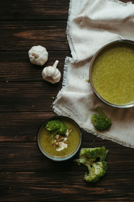 a bowl of soup next to a bowl of broccoli, a still life, pexels contest winner, ingredients on the table, nacre, a wooden, thumbnail