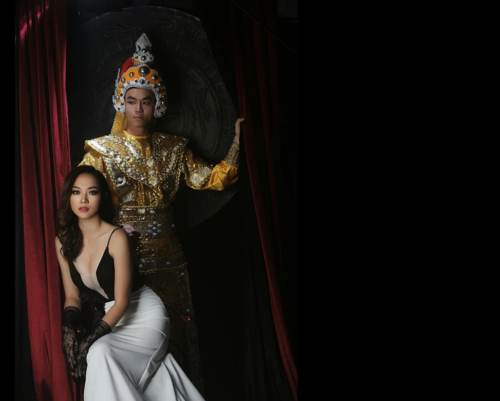 a couple of women standing next to each other, a portrait, by Natasha Tan, art photography, dressed as emperor, in style of thawan duchanee, studio backdrop, square