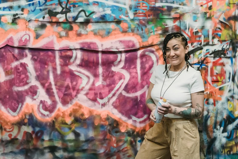 a woman standing in front of a graffiti covered wall, charli bowater and artgeem, meg kimura, mac miller, portrait featured on unsplash