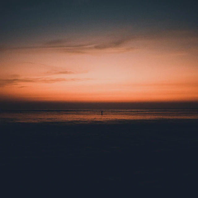 a person standing on a beach at sunset, unsplash contest winner, minimalism, dark orange night sky, hd wallpaper, lonely, sunfaded