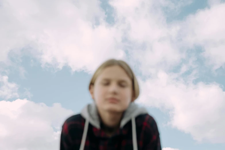 a close up of a person on a skateboard, by Attila Meszlenyi, trending on pexels, hyperrealism, girl clouds, head looking up, 8 k film still, overcast day
