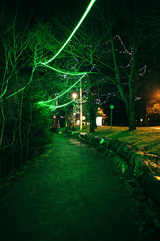 a street filled with lots of green lights, whimsical forest, bright castleton green, the river is full of lights, taken in the late 2010s