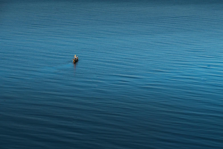 a small boat floating in the middle of a large body of water, by Eglon van der Neer, unsplash contest winner, minimalism, a pilgrim, dark blue, fisherman, movie still 8 k