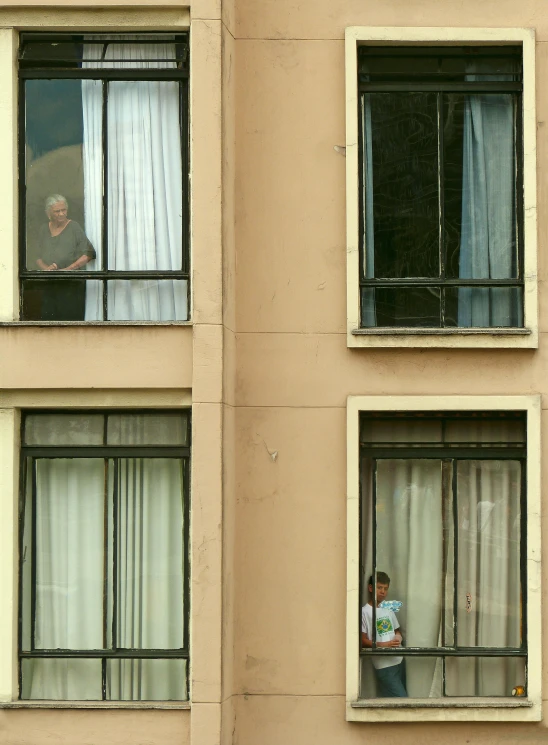 a couple of people that are looking out of a window, buenos aires, photographed for reuters, hotel room, two frail