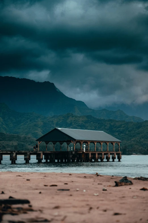 a pier in the middle of a body of water, a matte painting, by Daniel Seghers, pexels contest winner, kauai, gloomy weather. high quality, huts, she's sad