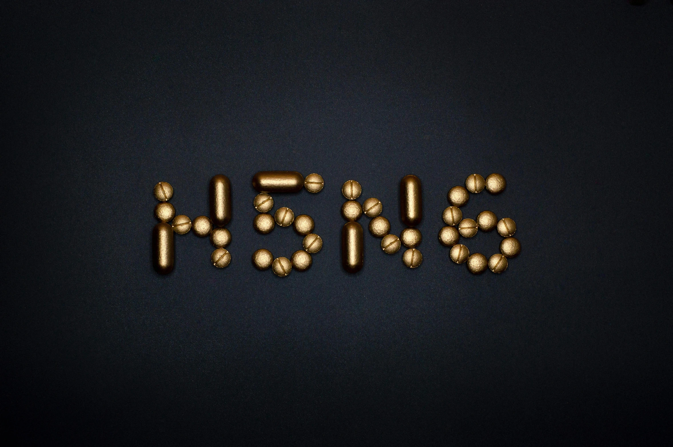 a number of pills sitting on top of a table, by Niko Henrichon, neoplasticism, golden chinese text, hongbsws, hydrogen. beautiful, mp5s