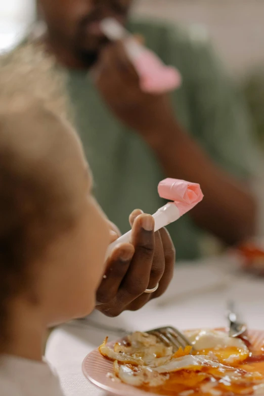 a small child eating food from a pink plate, pexels contest winner, visual art, paper origami, marshmallow, school class, blurred detail