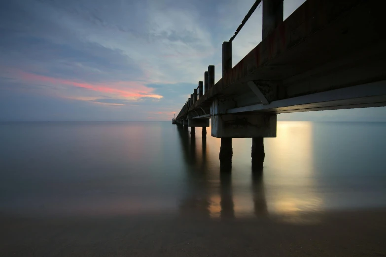 a long exposure photograph of a pier at sunset, by Andrew Geddes, medium format, fine art print, low - angle, grey