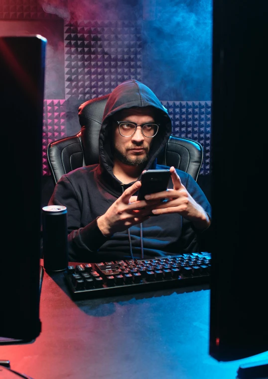 a man in a hoodie sitting in front of a computer, a portrait, featured on reddit, mobile game background, tech robes, no - text no - logo, embarrassing