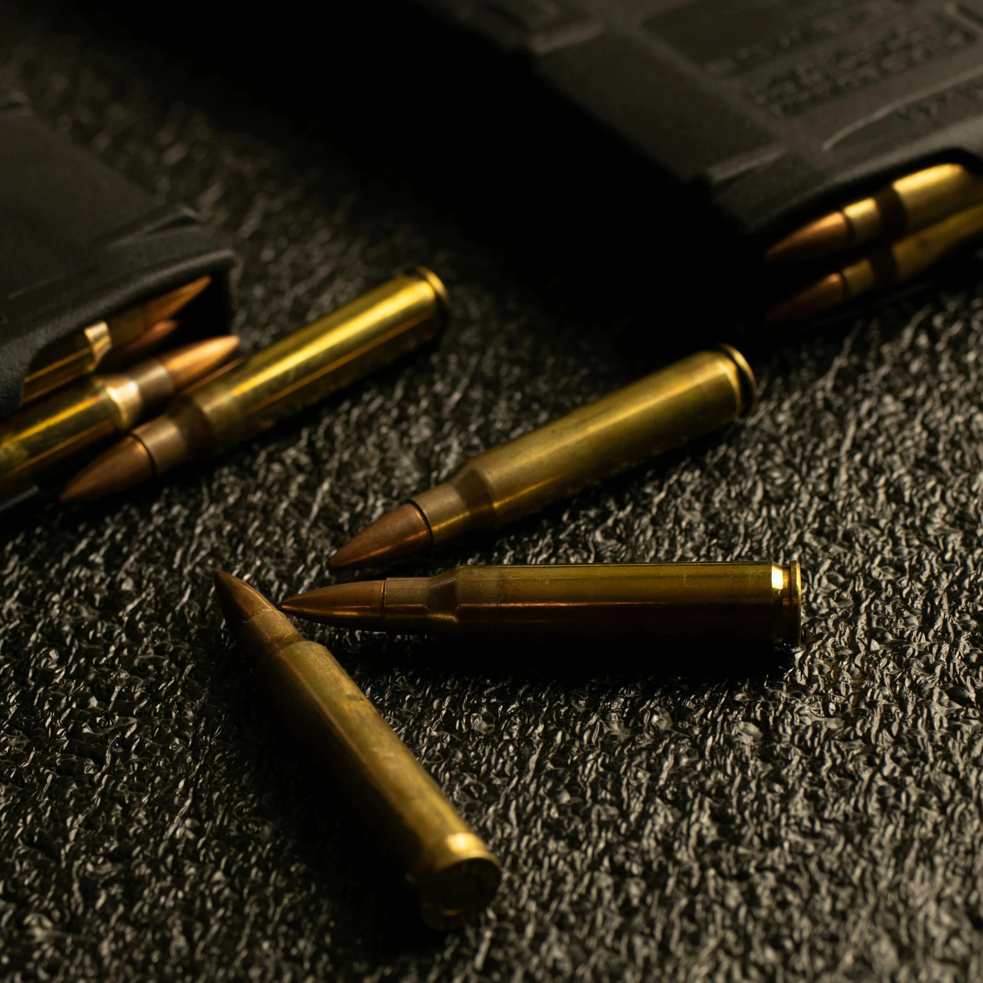 a couple of bullet shells laying on top of a wallet, a digital rendering, unsplash, rifles, detail shot, sleek spines, taken in the night