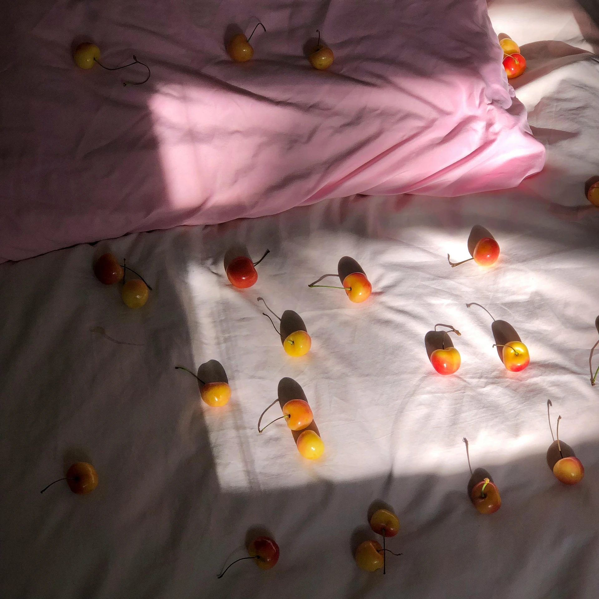 a bed with a lot of apples on it, an album cover, inspired by Elsa Bleda, unsplash, hyperrealism, pink and yellow, beds of shadows, taken on iphone 1 3 pro, miro petrov