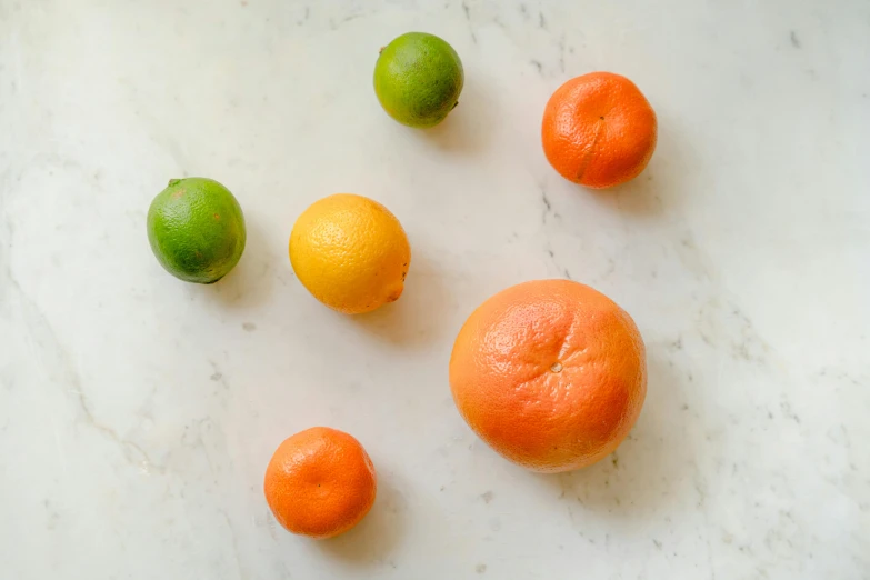 oranges, lemons and limes on a marble surface, by Carey Morris, pexels contest winner, broad shoulders, five planets, 6 pack, studio shot