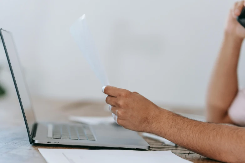 a man and a woman sitting at a table with a laptop, pexels contest winner, blank paper, background image, opening shot, thumbnail