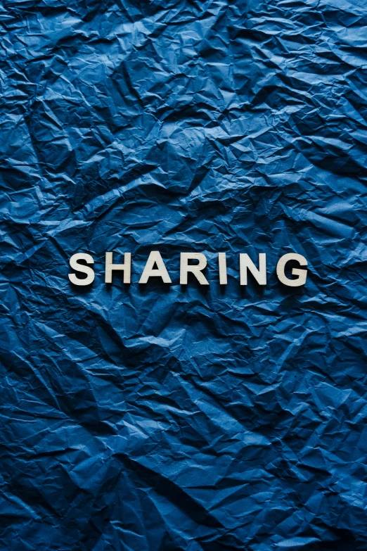 a blue crumpled paper with the word sharing written on it, an album cover, trending on unsplash, thumbnail, profile picture 1024px, shining metal, unsplash photo contest winner