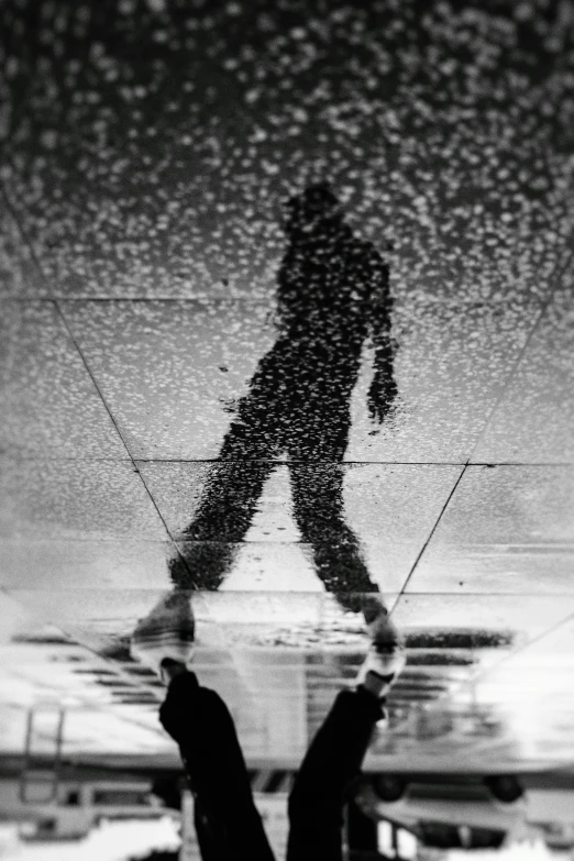 a black and white photo of a person walking in the rain, inspired by Vivian Maier, unsplash, conceptual art, reflections on a glass table, fractal human silhouette, ffffound, covered with tar