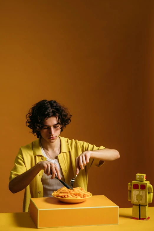 a man cutting a pizza with a knife and fork, an album cover, by Alexis Grimou, trending on pexels, wavy hair yellow theme, toy commercial photo, teenager, sculptor