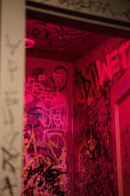 a bathroom with graffiti all over the walls, pexels, graffiti, dim red light, ((pink)), punk party, secret room upstairs