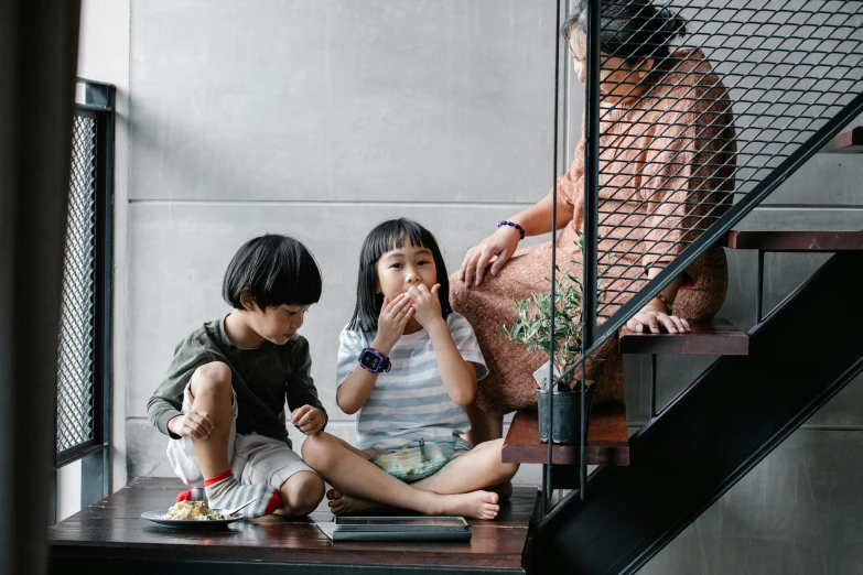 a couple of kids sitting on top of a wooden table, inspired by Ni Yuanlu, pexels contest winner, having a snack, in house, asian female, dwell