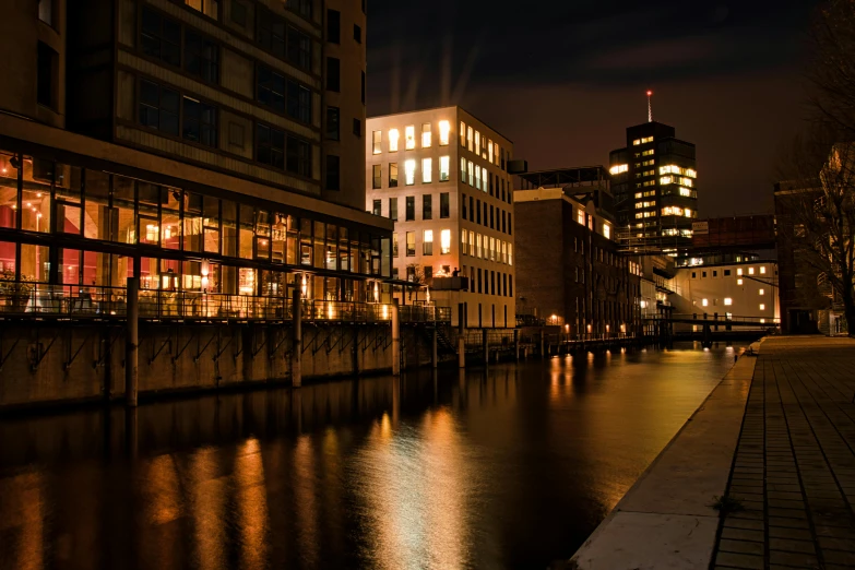 a river running through a city next to tall buildings, a photo, by Sebastian Spreng, candlelit, docks, thumbnail, high quality image