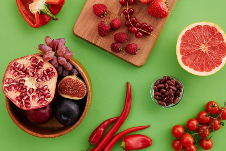 a variety of fruits and vegetables on a green surface, trending on pexels, red and purple, 🦩🪐🐞👩🏻🦳, red dish, background image